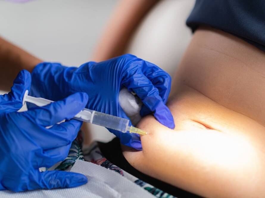 Peptide therapy is injected into a patient’s stomach.