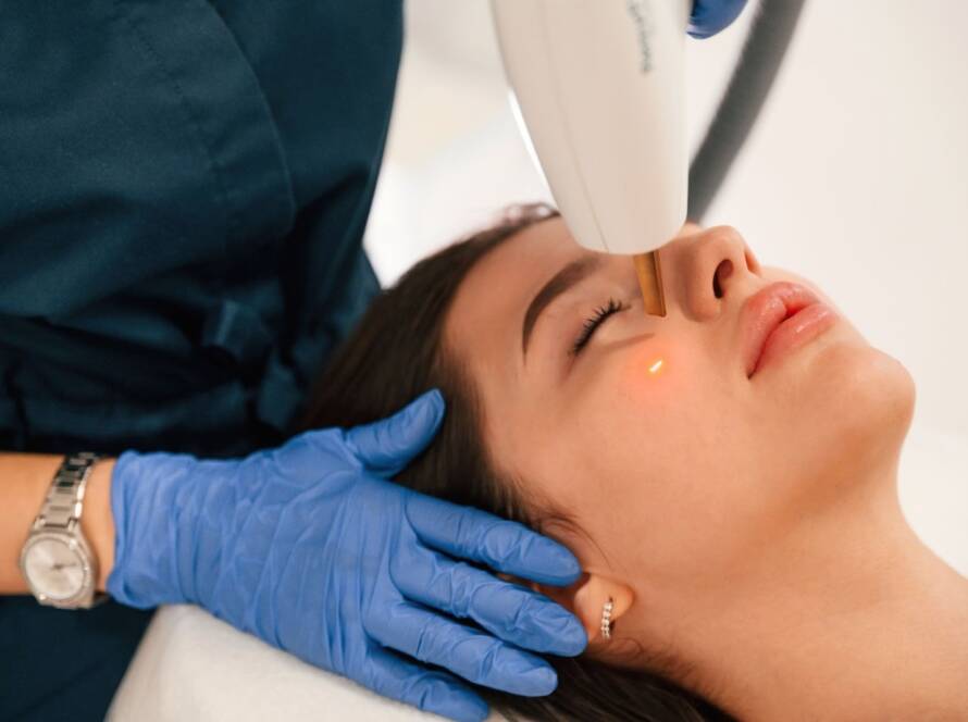 A woman is laying down and getting professional laser treatment.